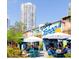 Outdoor seating area in a vibrant plaza with food stalls and high-rise building at 111 S Ashley Dr # 3409, Tampa, FL 33602