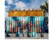 Painted shipping container with coordinates, serving as a unique structure at 111 S Ashley Dr # 3606, Tampa, FL 33602