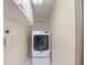 Bright laundry room with stacked washer and dryer at 271 Lake Tarpon Dr # 16, Palm Harbor, FL 34684