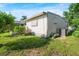 View of house side, AC unit, and grassy yard at 271 Lake Tarpon Dr # 16, Palm Harbor, FL 34684