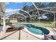 Relaxing kidney-shaped pool with screened enclosure at 6640 Clair Shore Dr, Apollo Beach, FL 33572