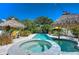 Inviting pool and spa with thatched-roof cabanas at 262 Banana Rd, Palm Harbor, FL 34683