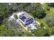 Aerial view of a house with solar panels, a large backyard, and pool at 262 Banana Rd, Palm Harbor, FL 34683