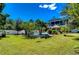 Expansive backyard with lush landscaping and a pool at 262 Banana Rd, Palm Harbor, FL 34683