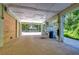 Covered parking area with gravel surface and exterior storage at 262 Banana Rd, Palm Harbor, FL 34683