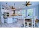 Modern kitchen with white cabinets, granite counters, and island at 262 Banana Rd, Palm Harbor, FL 34683