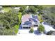 Two-story house with solar panels, elevated ground floor, and a large backyard at 262 Banana Rd, Palm Harbor, FL 34683