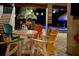 Covered patio with colorful chairs and table overlooking the pool at 262 Banana Rd, Palm Harbor, FL 34683