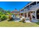 Backyard view highlighting the lush landscaping, tiki hut, and elevated deck at 262 Banana Rd, Palm Harbor, FL 34683