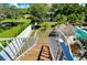 Private backyard with a pool, wooden stairs, and lush landscape at 262 Banana Rd, Palm Harbor, FL 34683