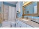 Bathroom with tiled shower, white vanity, and rustic framed mirror at 262 Banana Rd, Palm Harbor, FL 34683