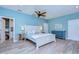 Relaxing bedroom with white bed and blue walls at 262 Banana Rd, Palm Harbor, FL 34683
