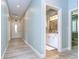 Light and airy hallway with tile flooring and access to bathroom at 262 Banana Rd, Palm Harbor, FL 34683