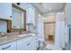 Bathroom with white vanity, stone shower, and light walls at 262 Banana Rd, Palm Harbor, FL 34683
