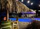 Relaxing poolside patio with colorful seating and string lights at 262 Banana Rd, Palm Harbor, FL 34683