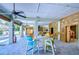 Outdoor patio with colorful chairs, a table, and a grill at 262 Banana Rd, Palm Harbor, FL 34683