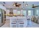 Bright and airy kitchen with white island, pendant lighting, and stainless steel appliances at 262 Banana Rd, Palm Harbor, FL 34683