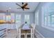 Bright kitchen with white cabinets, wood floors, and dining area at 262 Banana Rd, Palm Harbor, FL 34683
