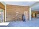 Covered patio with wood walls, stools, and a surfboard at 262 Banana Rd, Palm Harbor, FL 34683
