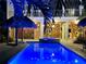 Lighted pool and spa at night, creating a relaxing ambiance at 262 Banana Rd, Palm Harbor, FL 34683