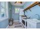 Laundry room with washer, dryer, sink, and ample storage space at 262 Banana Rd, Palm Harbor, FL 34683