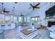 Open-concept living area with a kitchen, dining space, fireplace, and access to the outdoors at 262 Banana Rd, Palm Harbor, FL 34683
