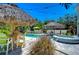Inviting pool area with tiki huts, patio furniture, and a spa at 262 Banana Rd, Palm Harbor, FL 34683