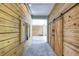 Interior hallway with light wood walls and sliding barn doors at 262 Banana Rd, Palm Harbor, FL 34683