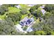 Aerial view of a house with solar panels, pool, and lush landscaping at 262 Banana Rd, Palm Harbor, FL 34683