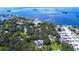 Aerial view of waterfront property with lush landscaping and private pool at 262 Banana Rd, Palm Harbor, FL 34683