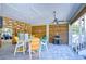 Outdoor patio with colorful chairs, a table, and a grill at 262 Banana Rd, Palm Harbor, FL 34683