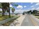 Street view of waterfront property with lighthouse and white picket fence at 262 Banana Rd, Palm Harbor, FL 34683
