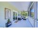 Peaceful screened porch with seating area overlooking backyard at 262 Banana Rd, Palm Harbor, FL 34683