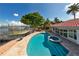 Kidney-shaped pool with spa and a spacious patio at 3111 E Vina Del Mar Blvd, St Pete Beach, FL 33706