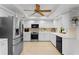 Bright kitchen with stainless steel appliances and white cabinets at 3111 E Vina Del Mar Blvd, St Pete Beach, FL 33706