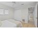 Comfortable bedroom with hardwood floors and hallway access at 3111 E Vina Del Mar Blvd, St Pete Beach, FL 33706