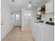 Bright laundry room with washer, dryer, and access to a bathroom at 3111 E Vina Del Mar Blvd, St Pete Beach, FL 33706