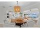 Dining room with octagonal table, chandelier, and water views at 3111 E Vina Del Mar Blvd, St Pete Beach, FL 33706