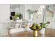 Bright dining area with wood table and white chairs at 3111 E Vina Del Mar Blvd, St Pete Beach, FL 33706