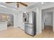 Modern kitchen features stainless steel refrigerator and light wood floors at 3111 E Vina Del Mar Blvd, St Pete Beach, FL 33706
