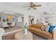 Open living area featuring a tan leather couch and a view to the dining room at 3111 E Vina Del Mar Blvd, St Pete Beach, FL 33706