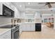 Kitchen with water views, stainless steel appliances, and white cabinets at 3111 E Vina Del Mar Blvd, St Pete Beach, FL 33706