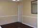 Empty bedroom with hardwood floors, light tan walls, and white trim at 7613 Hampshire Garden Pl, Apollo Beach, FL 33572