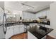 Modern kitchen with white cabinets, granite countertops and stainless steel appliances at 501 Knights Run Ave # 1215, Tampa, FL 33602