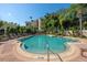 Community pool with lounge chairs and lush landscaping at 501 Knights Run Ave # 1215, Tampa, FL 33602