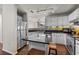 Modern kitchen with white cabinets, granite countertops, and island at 501 Knights Run Ave # 1215, Tampa, FL 33602