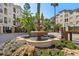 Community entrance with a fountain and lush landscaping at 501 Knights Run Ave # 1215, Tampa, FL 33602
