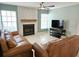 Living room with fireplace, wood mantle, and leather sofas at 2983 Bonaventure Cir # 103, Palm Harbor, FL 34684