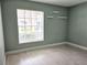 Simple bedroom with light walls, large window and light wood flooring at 2983 Bonaventure Cir # 103, Palm Harbor, FL 34684