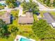 Aerial view showing home's location, pool, and landscaping at 1461 Cottonwood Ter, Dunedin, FL 34698